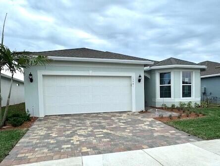 view of front of house with a garage and a lawn