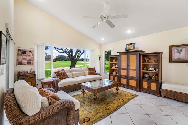 living room featuring high vaulted ceiling, ceiling fan, and light tile patterned flooring