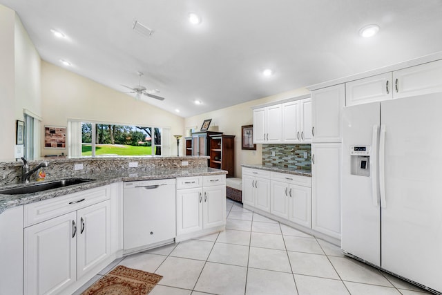 kitchen featuring ceiling fan, sink, white appliances, and vaulted ceiling