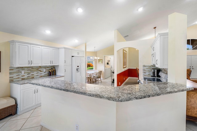 kitchen featuring white cabinetry, white appliances, backsplash, kitchen peninsula, and lofted ceiling