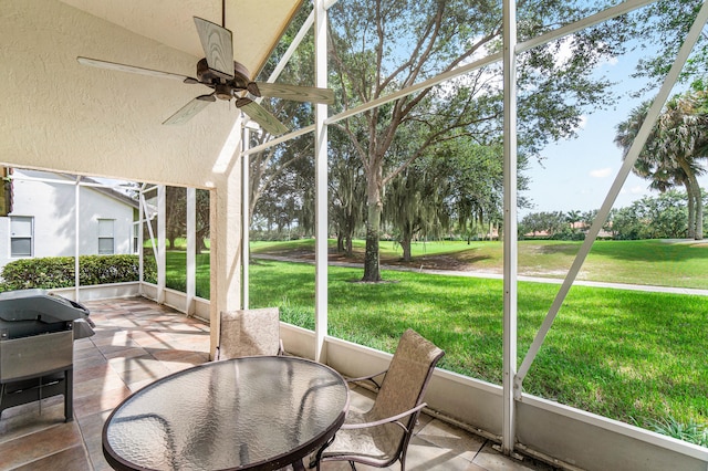 sunroom featuring ceiling fan