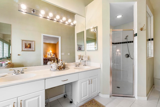 bathroom with vanity, a shower with shower door, and tile patterned flooring