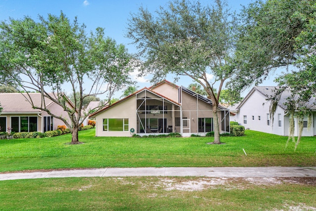 view of front of property with a front lawn and a sunroom