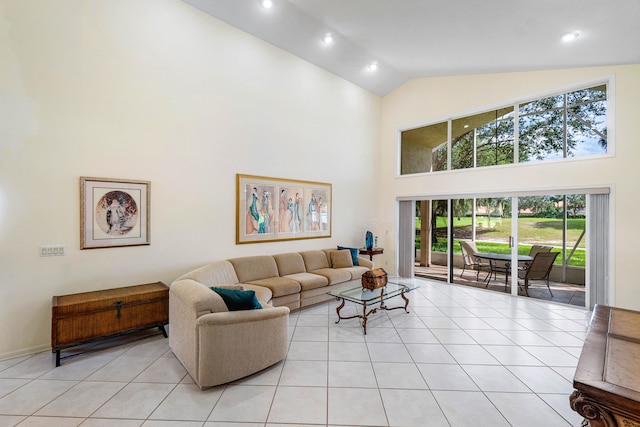 living room with high vaulted ceiling and light tile patterned floors