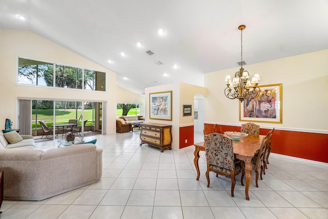 dining area featuring high vaulted ceiling, an inviting chandelier, and light tile patterned flooring