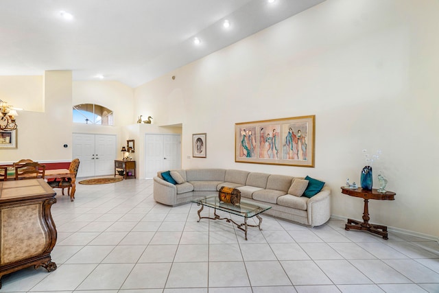 living room featuring high vaulted ceiling and light tile patterned flooring