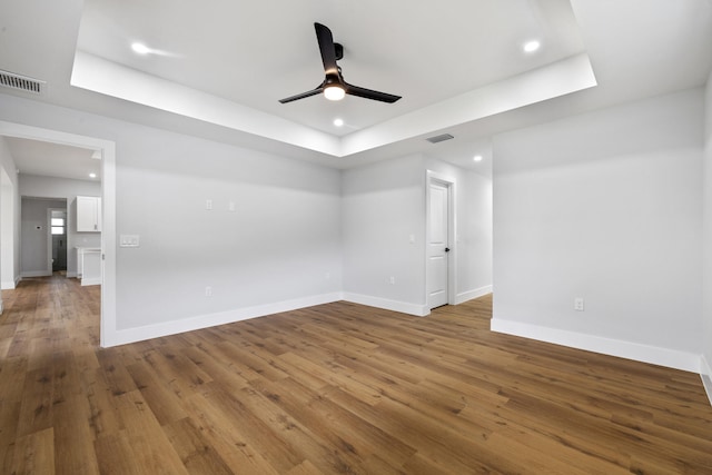 spare room featuring baseboards, visible vents, wood finished floors, and recessed lighting