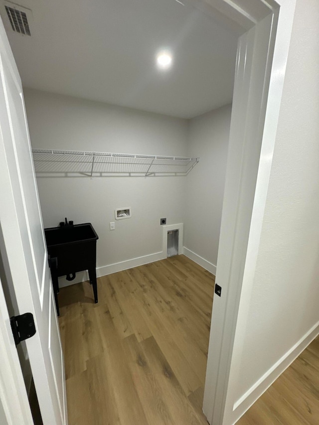 laundry room featuring hookup for an electric dryer, wood-type flooring, and washer hookup