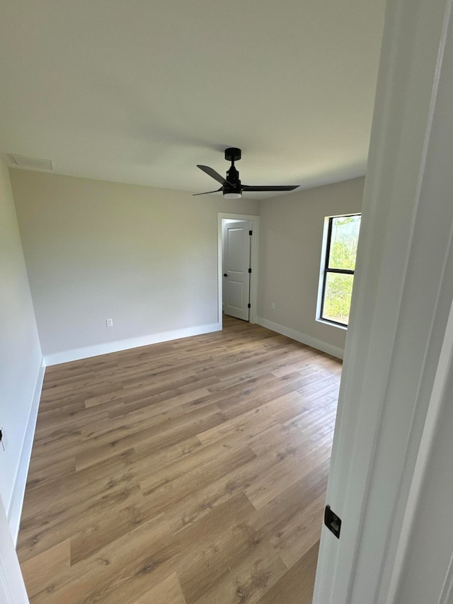 unfurnished room featuring ceiling fan and light wood-type flooring