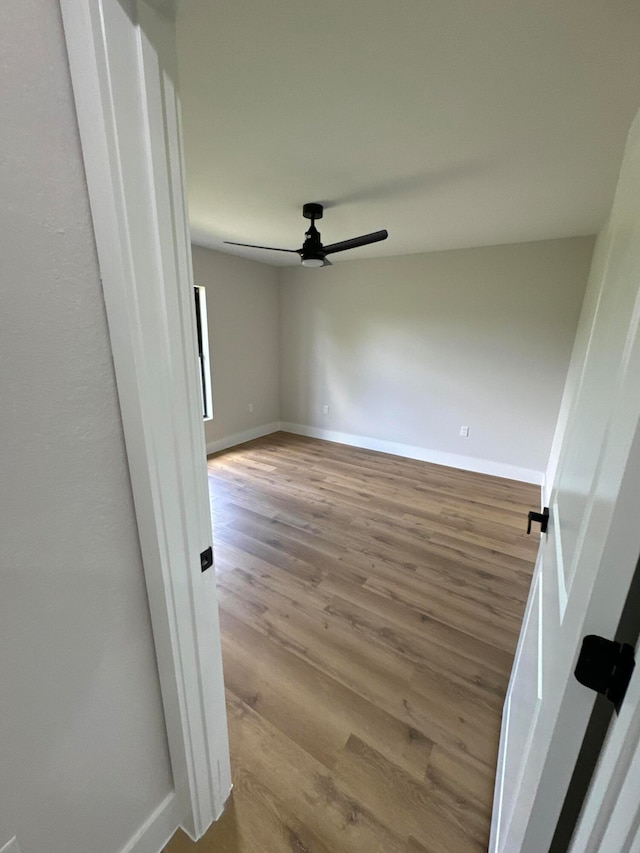 unfurnished room with ceiling fan and light hardwood / wood-style flooring