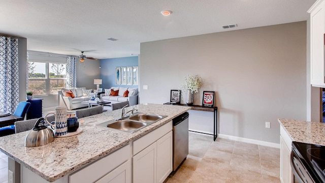 kitchen featuring dishwasher, sink, ceiling fan, a center island with sink, and white cabinets