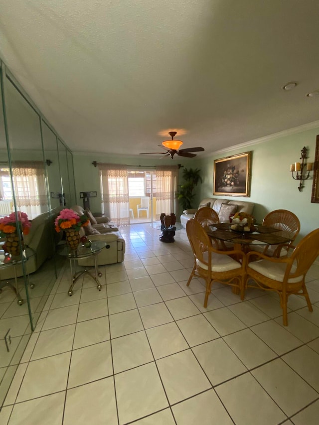 dining room with ceiling fan, light tile patterned floors, and crown molding