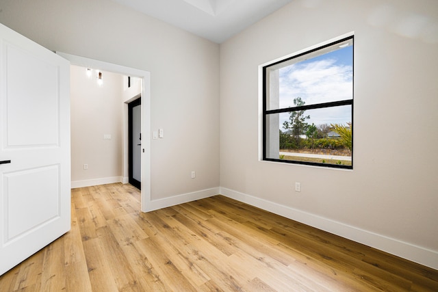 unfurnished room featuring light wood-style floors and baseboards