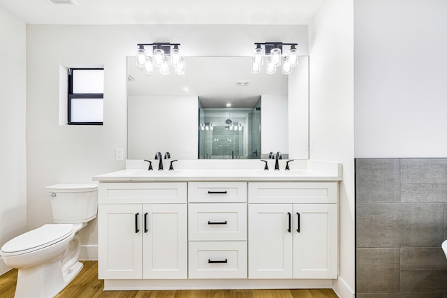 bathroom featuring walk in shower, vanity, toilet, and wood-type flooring