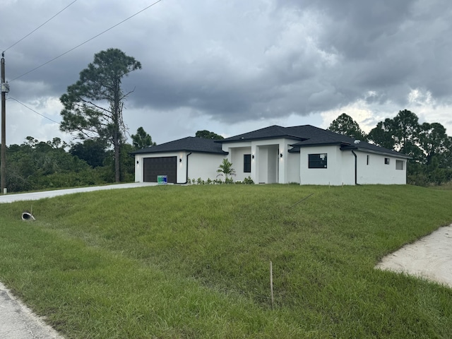 view of front of house with a garage and a front lawn