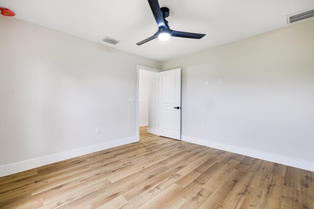 spare room featuring light hardwood / wood-style flooring and ceiling fan