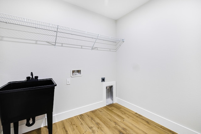 washroom featuring wood-type flooring, hookup for an electric dryer, and hookup for a washing machine