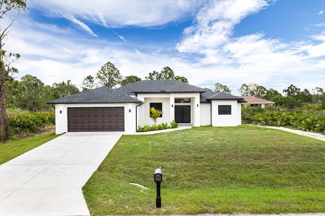 view of front of house featuring a garage and a front lawn