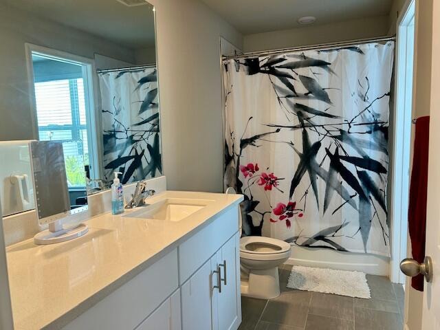 full bathroom featuring vanity, toilet, tile patterned floors, and shower / bath combo