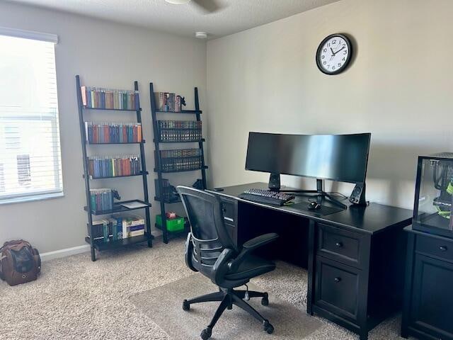 office space with light carpet and a textured ceiling