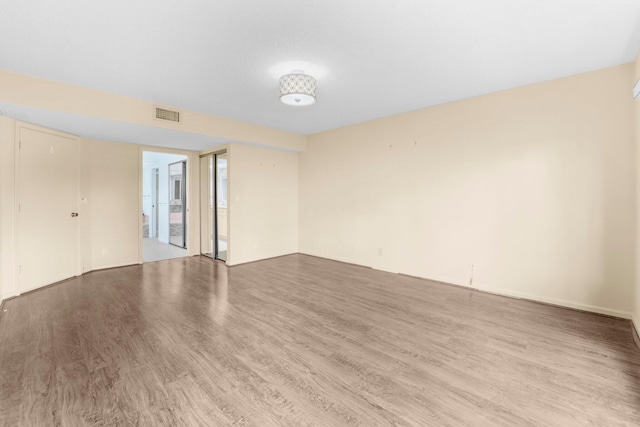 unfurnished room featuring hardwood / wood-style flooring