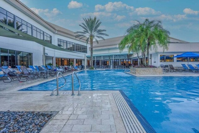 view of swimming pool with a patio and pool water feature