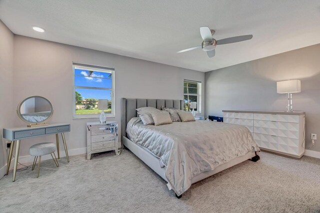 living room featuring light wood-type flooring, ceiling fan, and vaulted ceiling