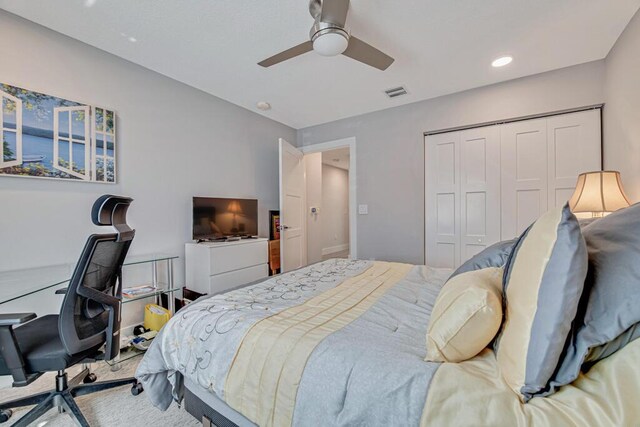 bedroom with ceiling fan and light colored carpet