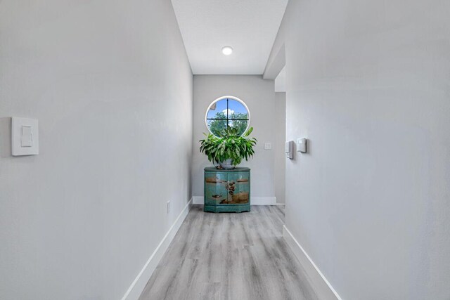 room details with a barn door, wooden walls, and elevator