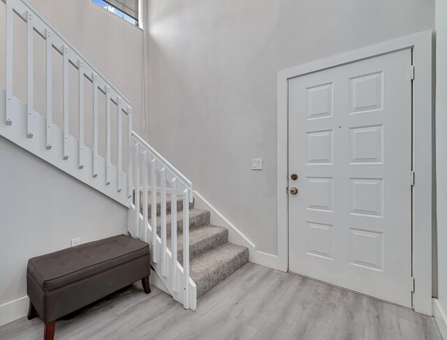 stairway with hardwood / wood-style floors