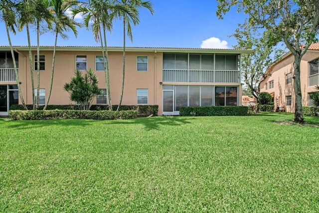 rear view of property with a yard