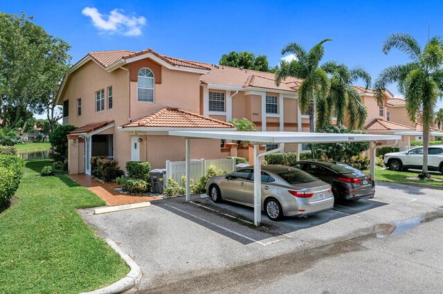 view of front of property featuring a carport