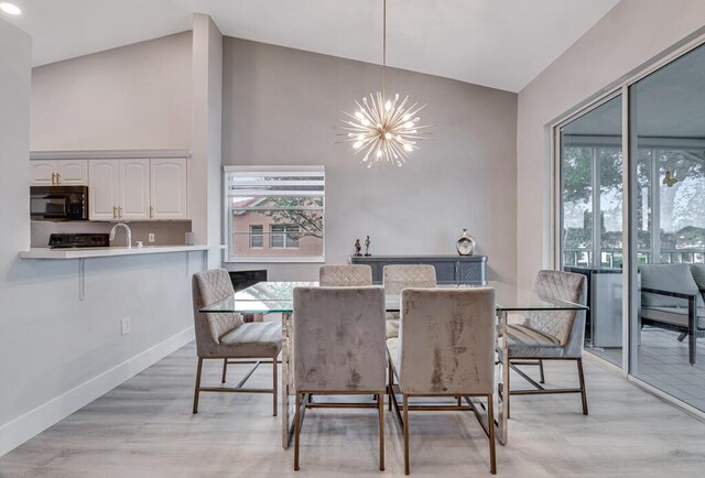 living room featuring high vaulted ceiling and light hardwood / wood-style floors