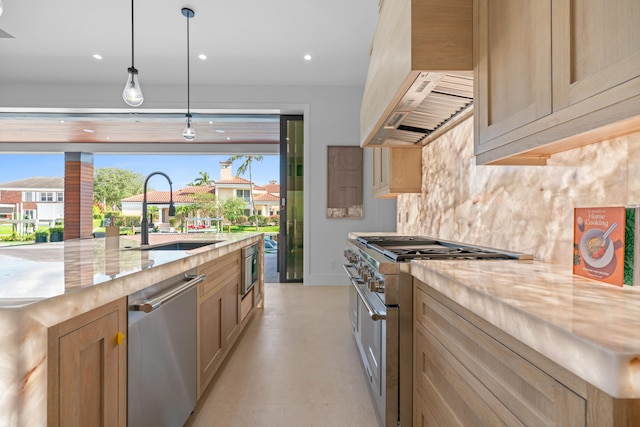 kitchen with decorative light fixtures, stainless steel appliances, light brown cabinetry, sink, and custom range hood