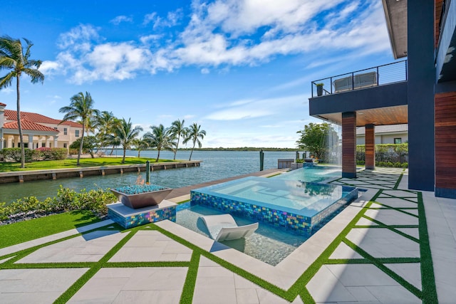 view of pool with an in ground hot tub and a water view