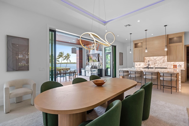 dining area featuring a water view and a chandelier