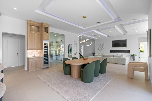 kitchen with plenty of natural light, decorative light fixtures, light brown cabinets, and decorative backsplash