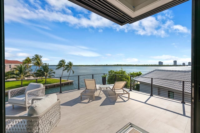 view of patio / terrace featuring a water view and a balcony