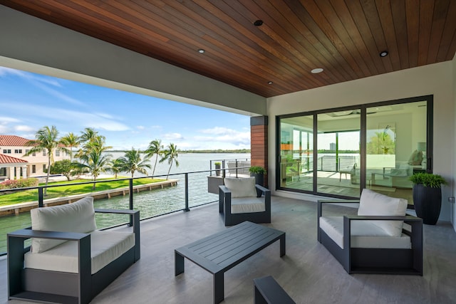 view of patio featuring a water view, an outdoor living space, and a balcony