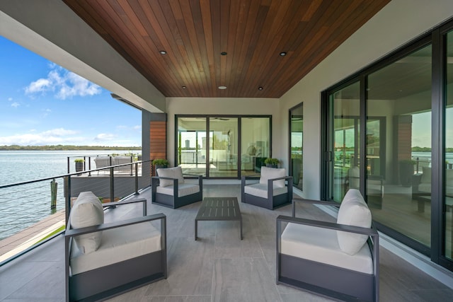 balcony with a water view and an outdoor living space