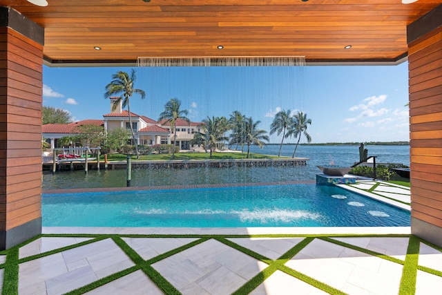 view of pool featuring pool water feature and a water view