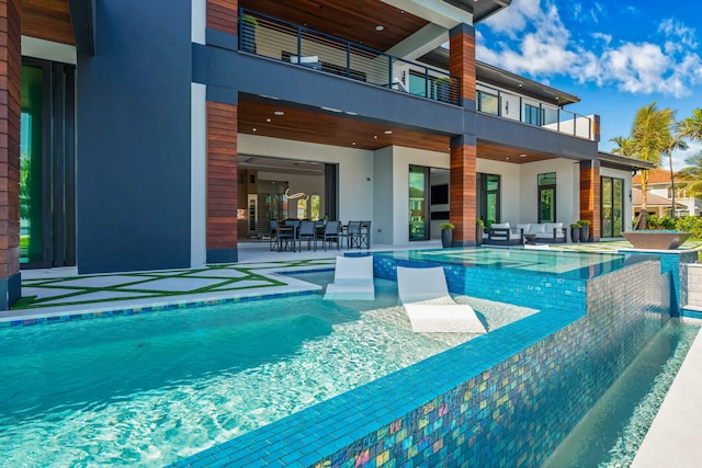 view of swimming pool with an outdoor living space and a patio area