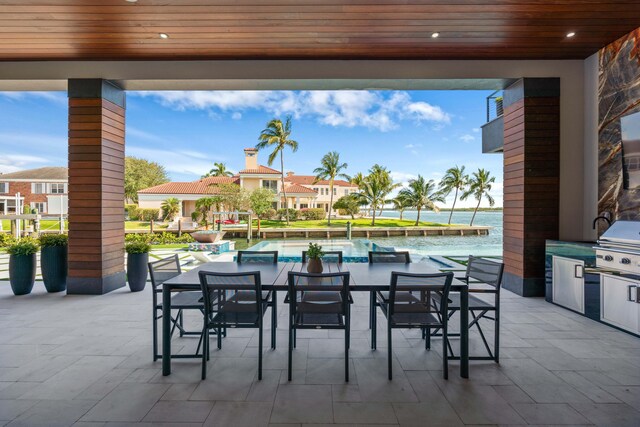 view of patio / terrace with a water view, grilling area, and area for grilling