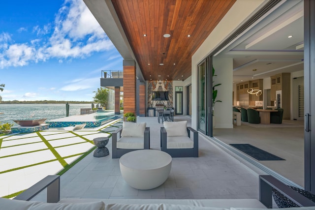 view of patio with an outdoor living space and a water view