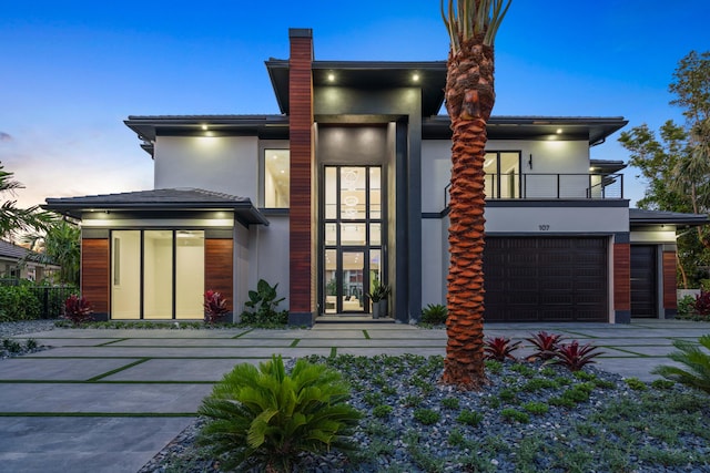 contemporary home with a balcony and a garage