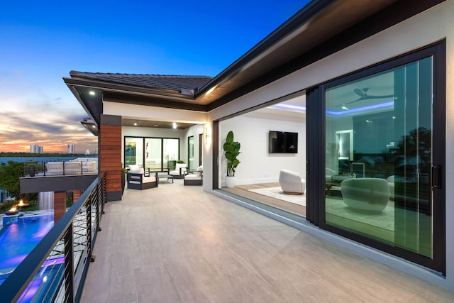 balcony at dusk with an outdoor hangout area