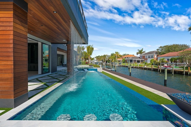 view of swimming pool featuring a water view, a patio area, a dock, and pool water feature