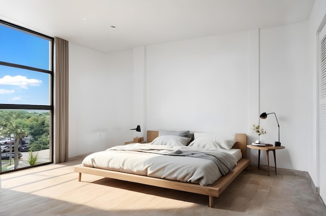 bedroom with hardwood / wood-style floors and floor to ceiling windows