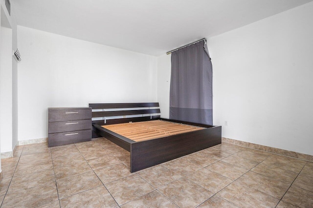 unfurnished bedroom featuring light tile patterned floors