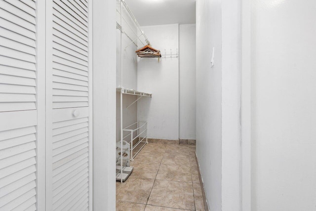 spacious closet with light tile patterned floors